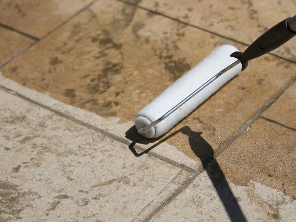 Applying sealer to a clean hardscape surface