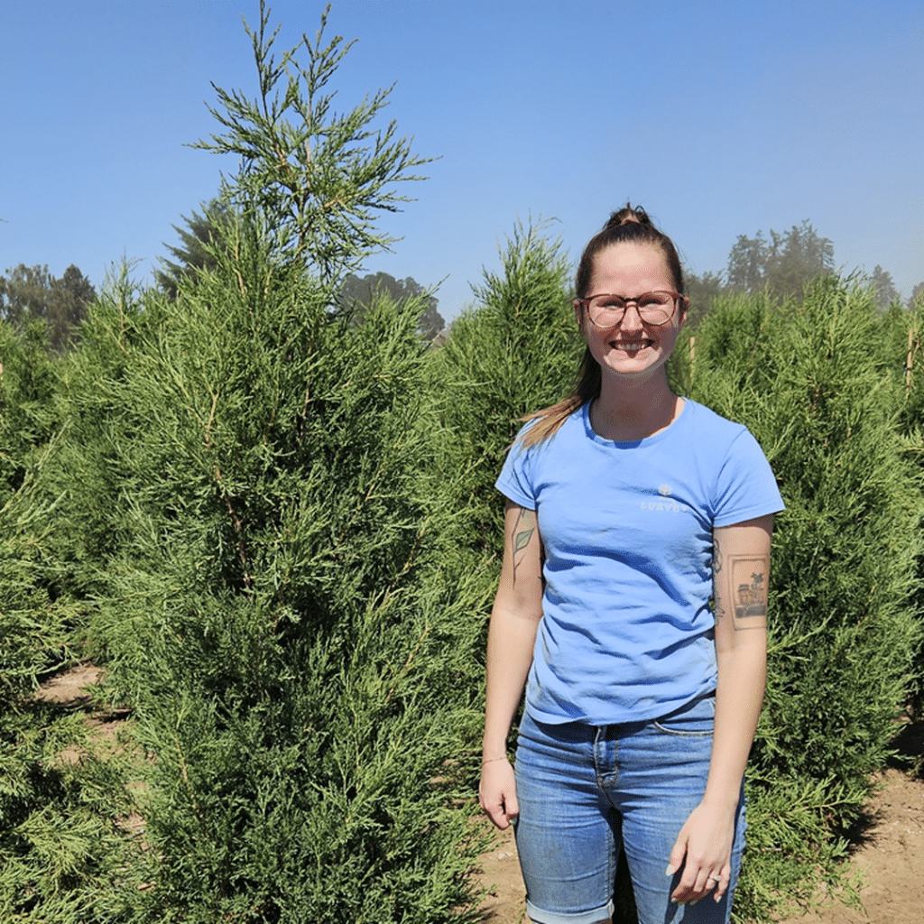 Cem next to a juniper in a nursery field