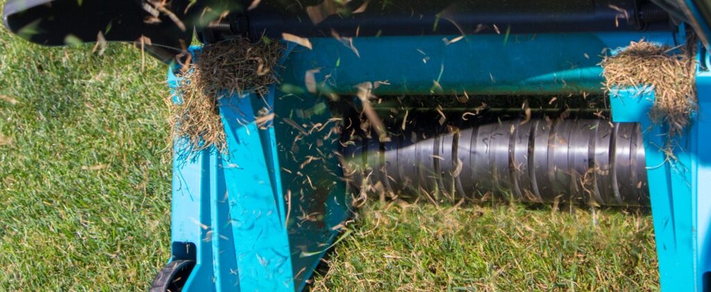 Dethatching machine working on lawn