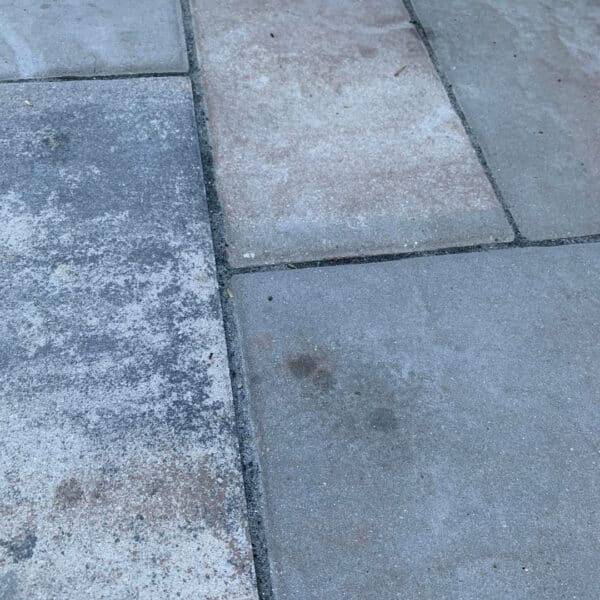 Set-in oil stains on a concrete paver driveway